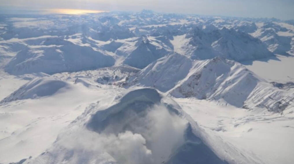 Snowy mountain range at golden hour